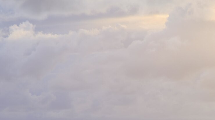 timelapse of clouds with blue, grey, white, yellow colours