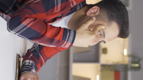 Vertical-video-of-Lonely-man-thinks-of-his-family.