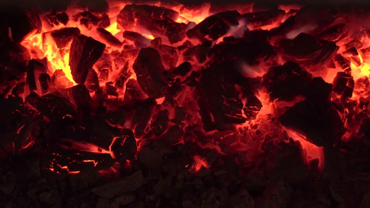 A blazing fire in the dark in a fireplace or stove. Ignition of wood in the fire. A bright burning flame. Sparks and flames in the dark. Incandescent heat and flames.A fiery blazing bonfire. Brazier