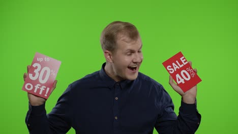 man showing sale purchase discounts advertisement inscriptions, looking satisfied with low prices