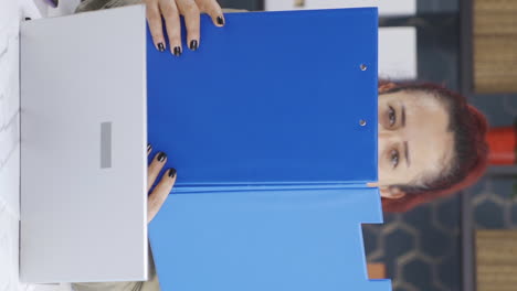 vertical video of cheerful business woman working on files.