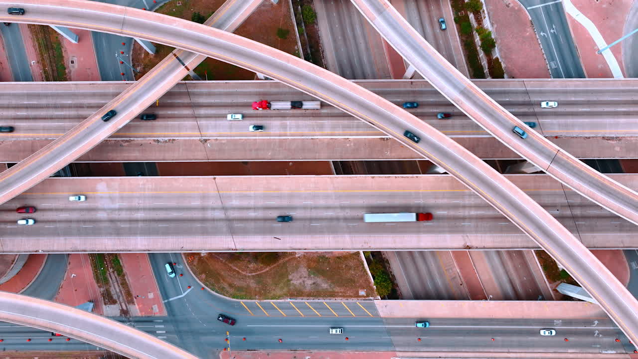 Descend over the highways and trestles with multiple cars moving by. Traffic in the modern city
