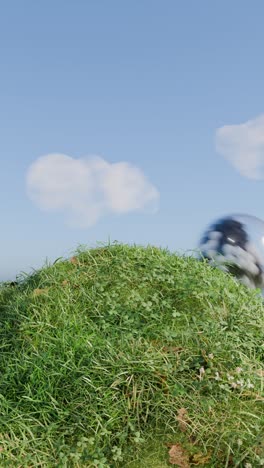 green hill under a blue sky