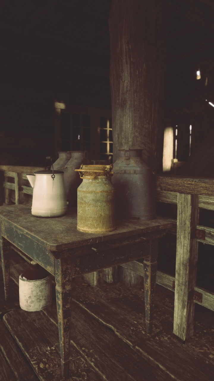Rustic interior of an old barn showcasing vintage pottery and wooden furniture