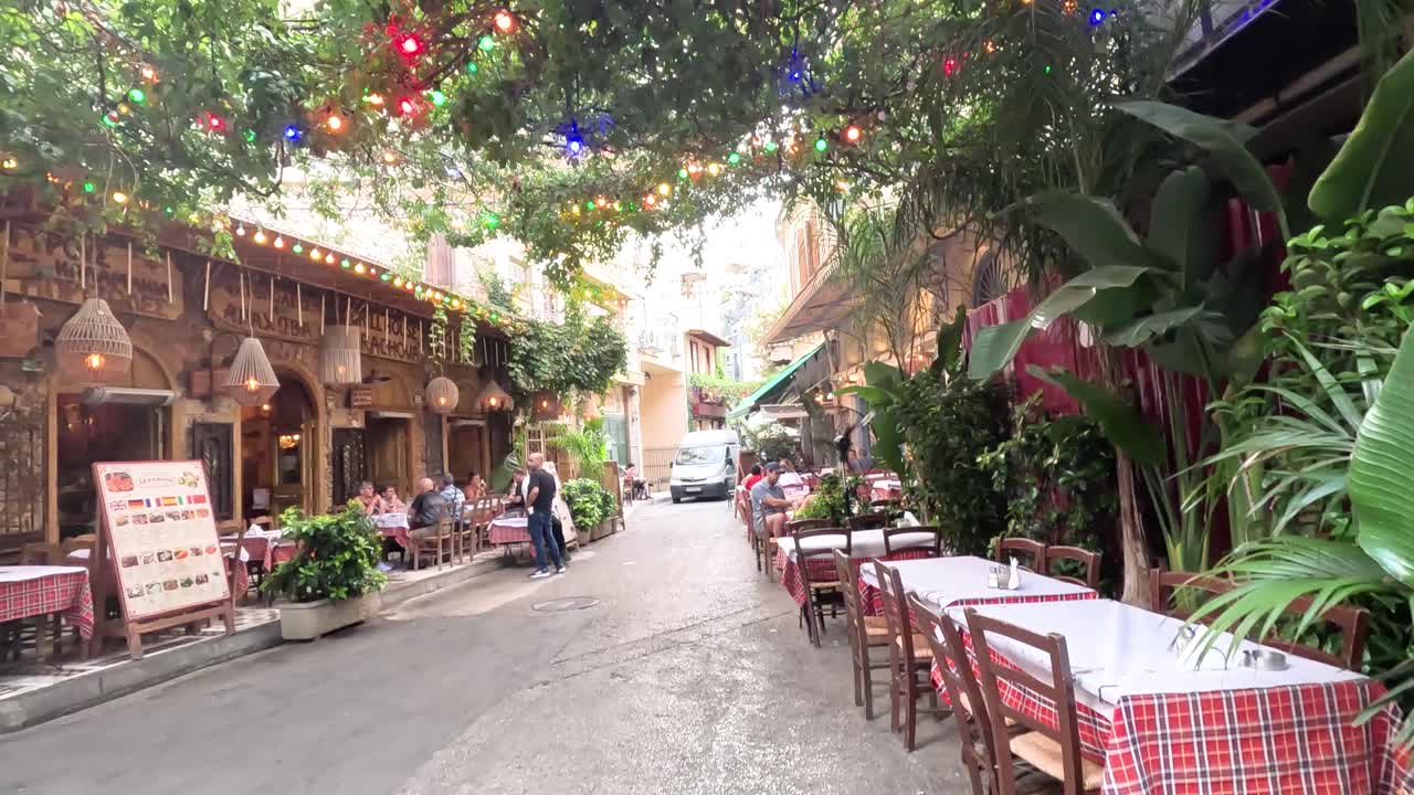 Walking through a beautiful Greek center with restaurants in Athens.