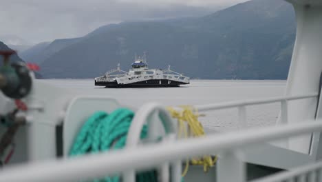 two passenger ferries cross the norwegian fjord passing each other