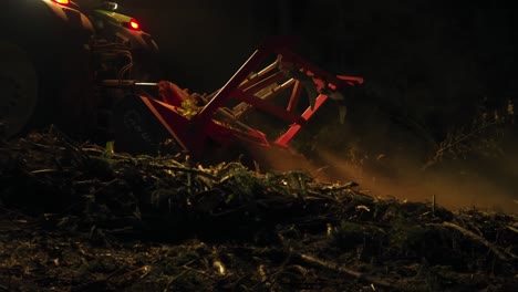 Forest-mulcher-processes-tree-remains-after-bark-beetle-infestation-at-night