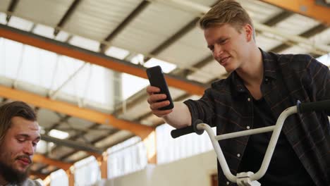 BMX-riders-talking-in-an-empty-warehouse