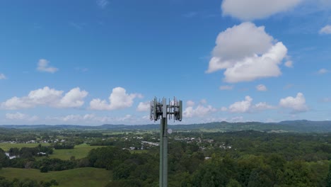 cell tower rising above lush green landscape