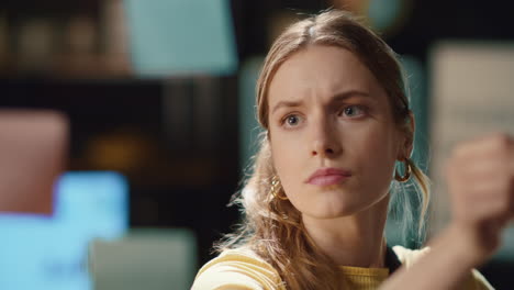 portrait of focused hipster girl reading stickers on glass board in night office