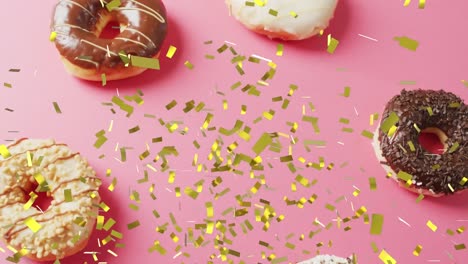 animación de confeti cayendo sobre las rosquillas en fondo rosa.