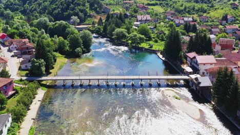 aerial over bridge connecting to historical village of kulen vakuf in bosnia and herzegovina