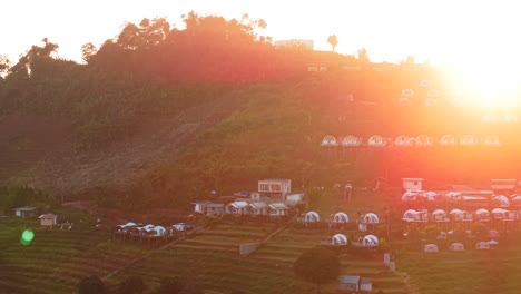 glamping cabins on a mountain at sunset