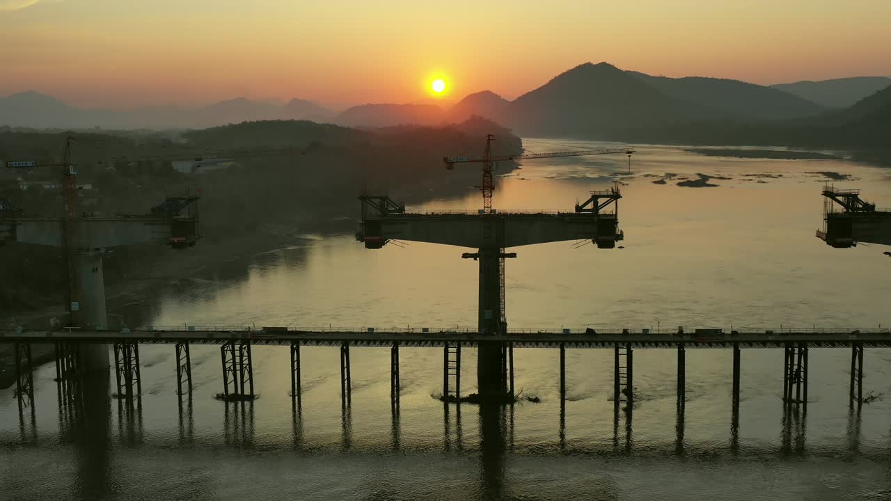 Bridge Construction Over River at Sunset