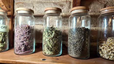 assortment of dried herbs and teas in glass jars