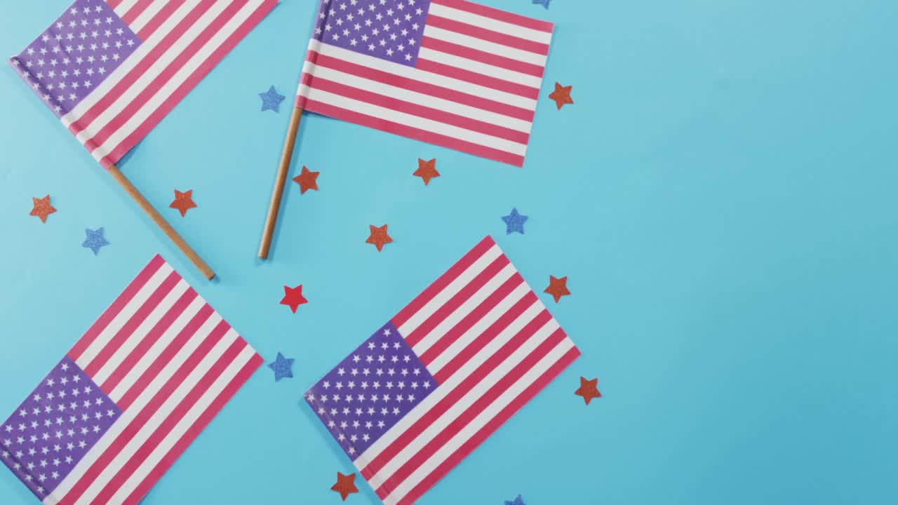 American flags with red and blue stars lying on blue background