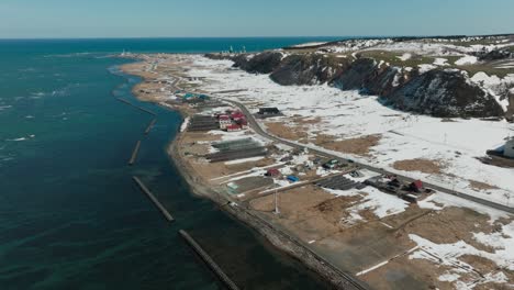 aerial view of chomes along the blue sea in wakkanai during winter in hokkaido, japan.