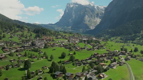 sliding aerial view of grindelwald and the swiss alps in switzerland