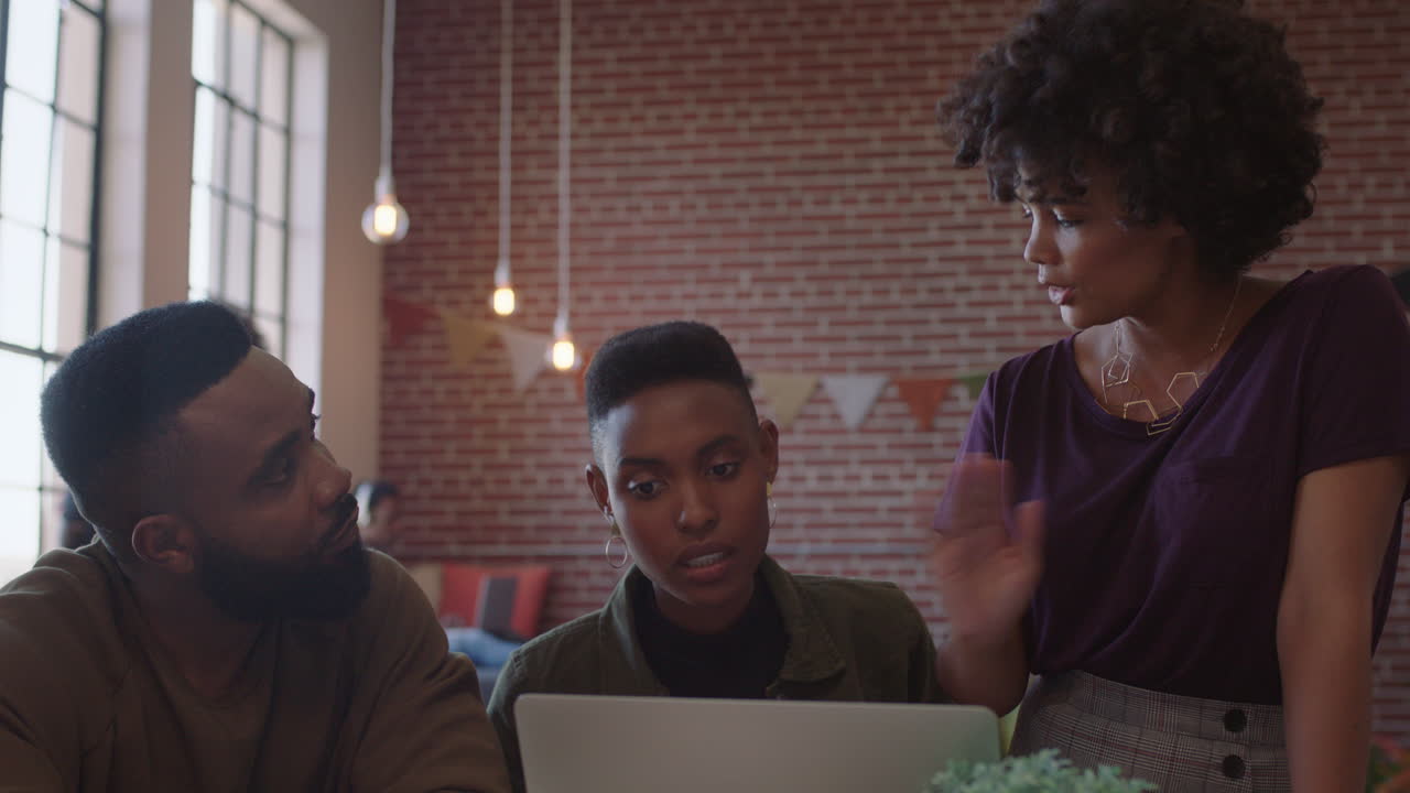 professional black business people meeting team leader woman training colleagues sharing ideas on laptop computer brainstorming in modern office workplace