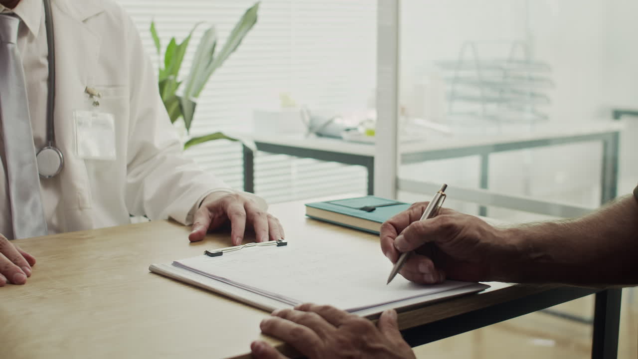 Unrecognizable Doctor Giving Document to Sign to Patient
