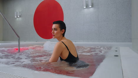 woman relaxing in a modern hot tub