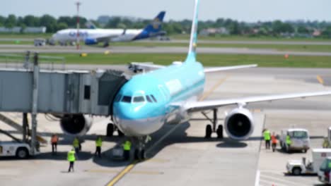 airplane at gate: a captivating scene of ground crew and aircraft ready for departure in a modern airport environment