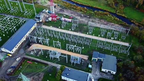 aerial drone fly over industrial power plant next to a river and a green forest