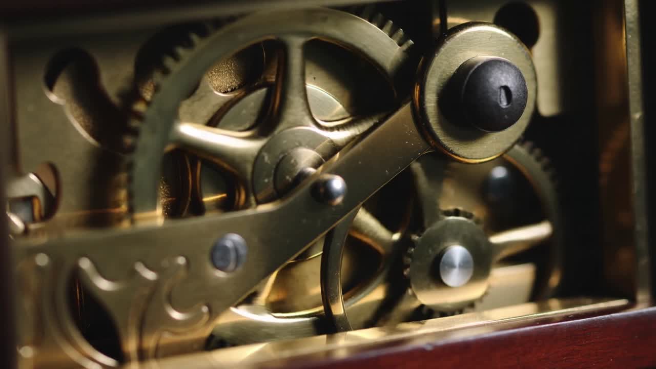 Starting brass movement advancing gears in wooden case with escapement oscillating keeping time
