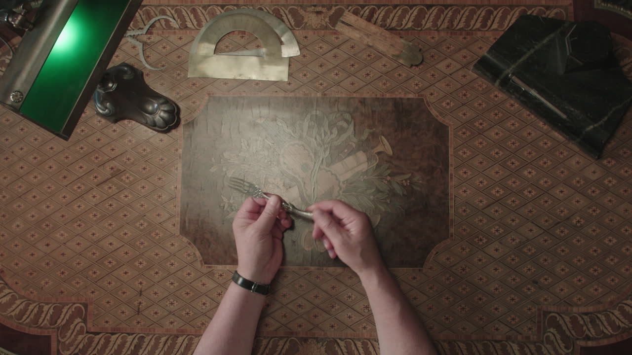 An older man evaluates an antique fork