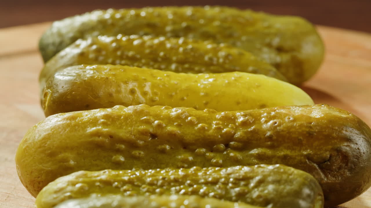 Close-up of pickled cucumbers on a wooden board