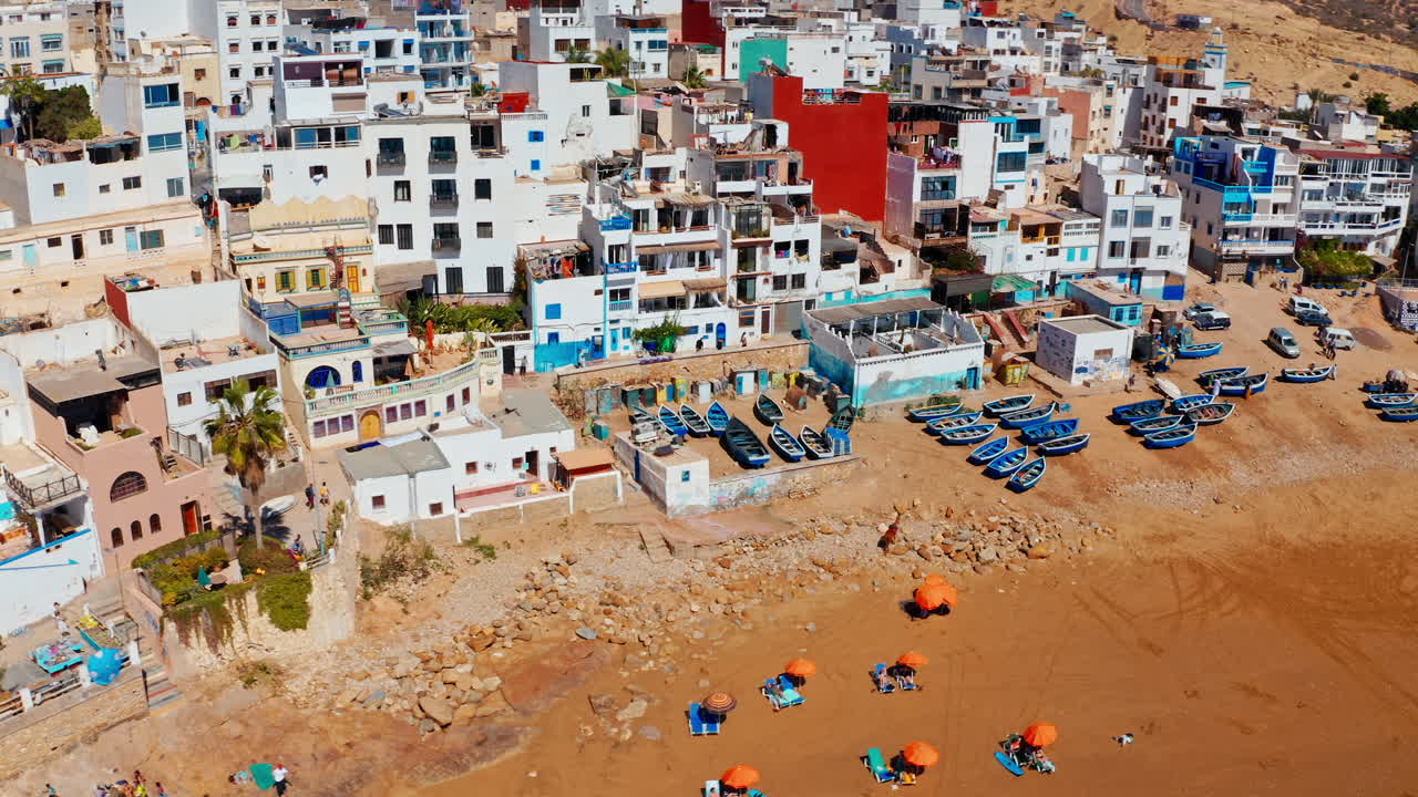Aerial drone shot over the local beach town of Taghazout in Morocco.