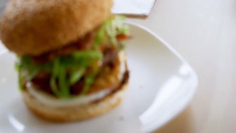 Burger-on-the-table-in-cafeteria-4k