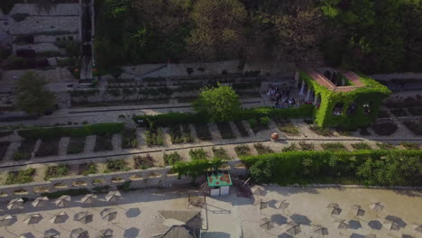 Drone-shot-of-wedding-ceremony-in-Balchik-Palace-revealing-coastline-and-Black-Sea