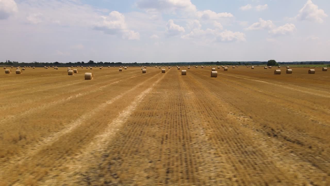 Wide trucking shot with harvested farmland