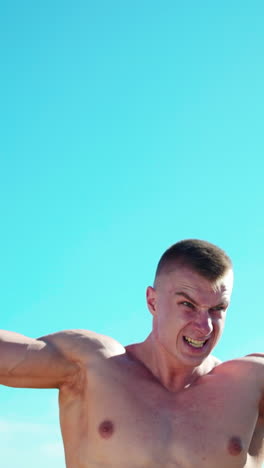 workout fitness sport. concentrated young sportsman outdoors exercising for upper arms with dumbbells