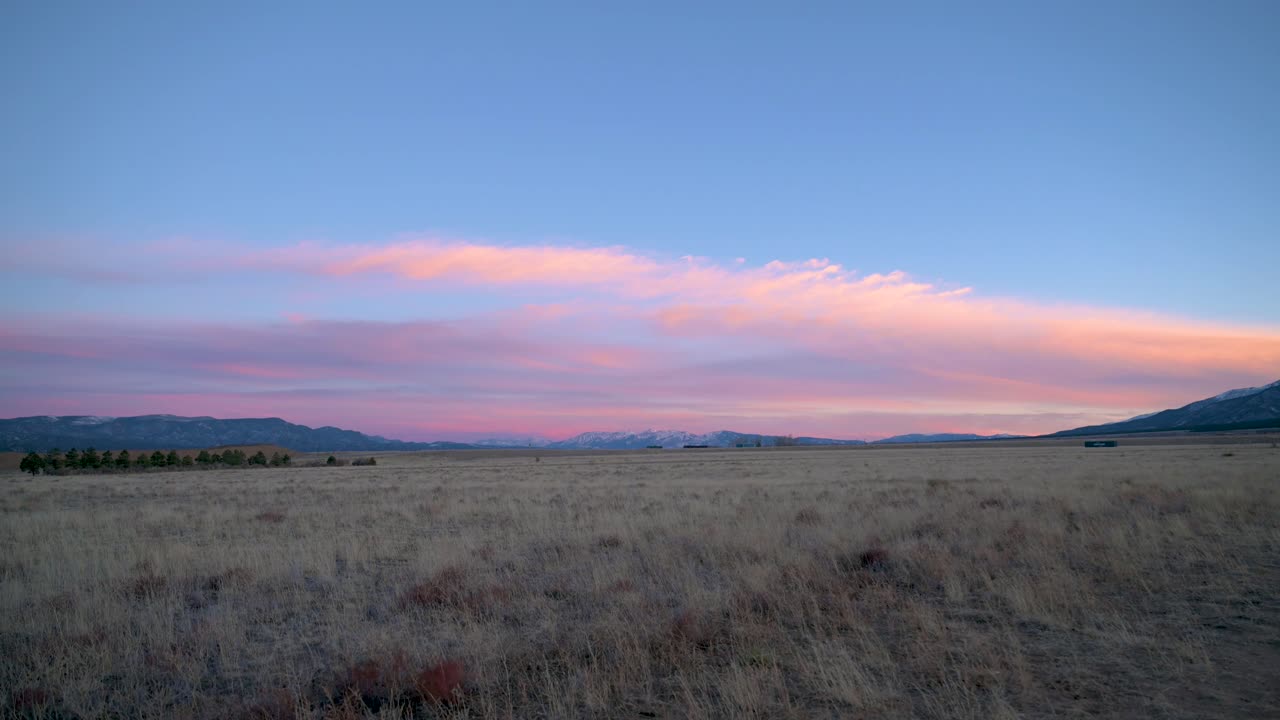 Pink clouds over the plains of Colorado between the Rocky Mountains, static