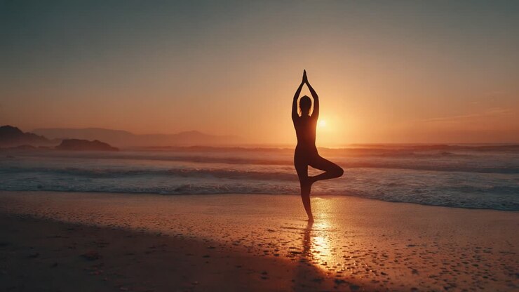 A Serene Sunset Silhouette: A Tranquil Figure Practicing Yoga on the Beach, Embracing Nature's Beauty and Calmness Amidst Waves and Golden Light