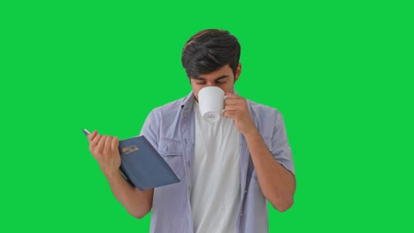 Concentrated-Indian-boy-reading-a-book-Green-screen