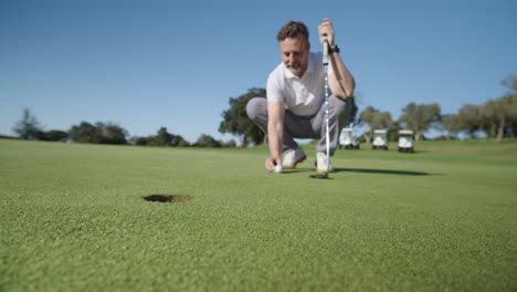 a golfer putting on a golf course