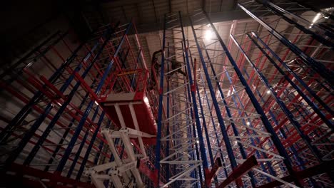 big and modern warehouse under construction, featuring metal shelving and other industrial equipment.