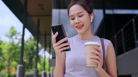 casual walking while business discussion at office corridor,asian female digital nomad freelance entrepreneur casual working while travel vacation outdoor corridor workplace,smiling female smartphone