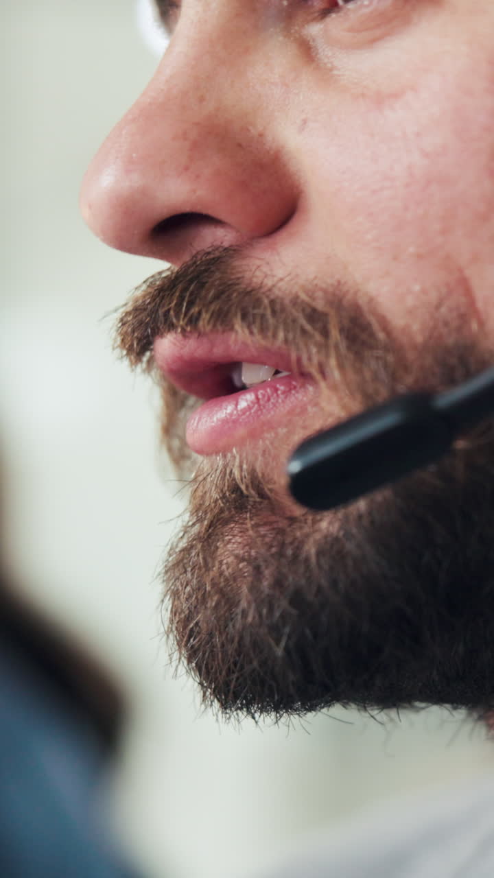 Close-up of Bearded Man Speaking into Headset Microphone