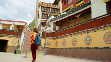 tourist stares in wonder at the beautiful architecture of spituk monastry at ladakh, showcasing serene architecture outdoors