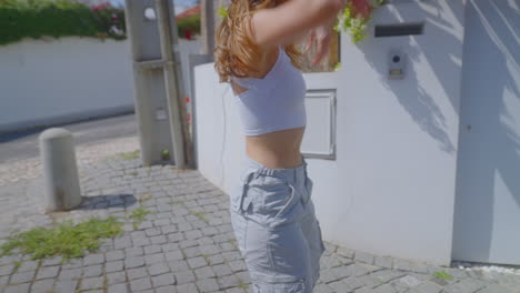 young woman walking outdoors in stylish clothes