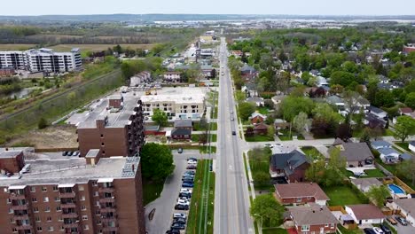 Flying-over-Milton-neighborhood-near-train-tracks-on-a-cloudy-day