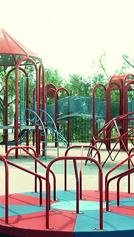 a red and blue carousel in a playground