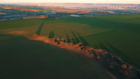 sunset over farmland with long shadows