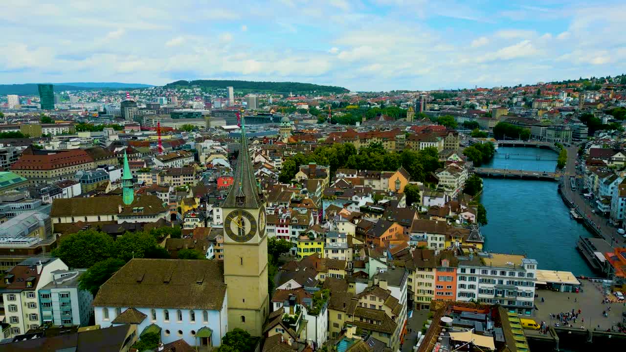 4K Drone Video of the Historic Fraumünster and St. Peter Churches on the banks of the Limmat River in Downtown Zurich, Switzerland