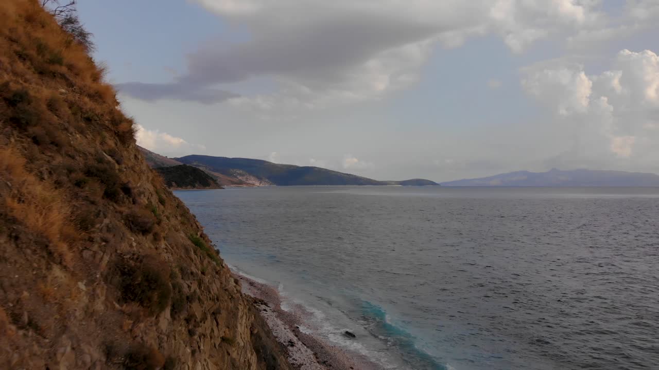 Rocky formations on beautiful seaside of Ionian sea with Corfu island in background