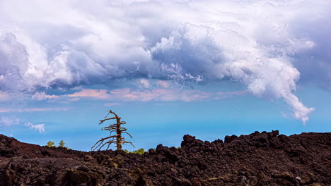 Mount-Etna,-Sicily,-Italy---Close-up-view-of-soil-from-previously-erupted-crater-of-the-mountain-at-daytime-with-white-clouds-passing-by-in-timelapse